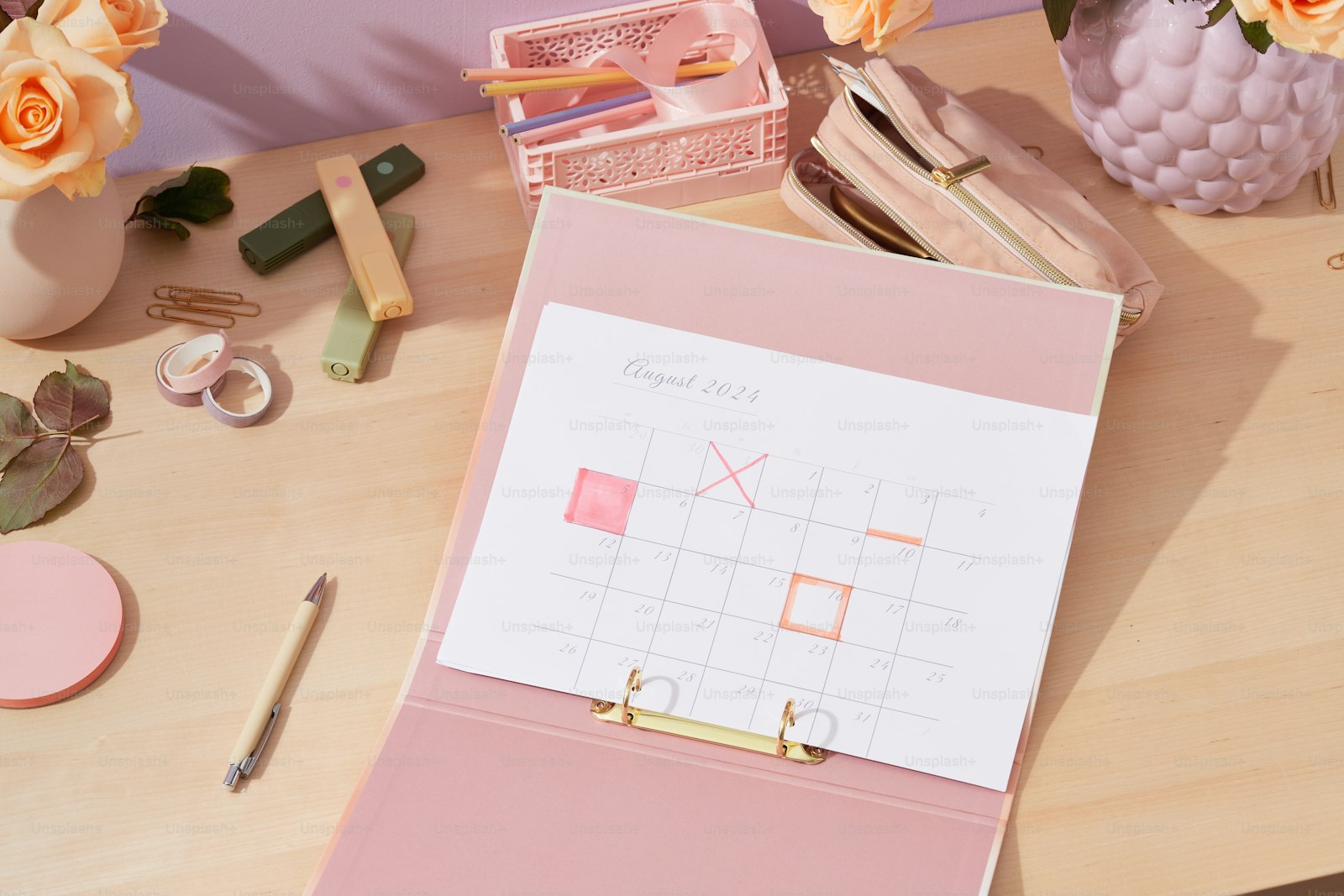 Desk with a planning calendar and office supplies